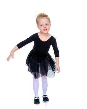 A gymnast girl prepares for the exercise. The concept of childhood and sport, a healthy lifestyle. Isolated on white background.