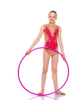 A girl gymnast performs an exercise with a hoop. The concept of gymnastics and fitness. Isolated on white background.