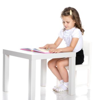 Little girl with book. The concept of education in school or kindergarten. Isolated over white background