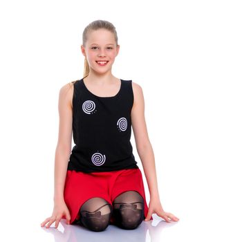 Beautiful little girl kneels in the studio on a white background. The concept of beauty and fashion, children's emotions. Isolated.