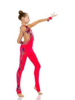 A gymnast girl prepares for the exercise. The concept of childhood and sport, a healthy lifestyle. Isolated on white background.