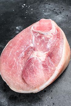 Slice of raw pork knuckle, leg. Farm fresh meat. black background. Top view.