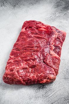 Raw piece of marble beef brisket meat. White background. Top view.