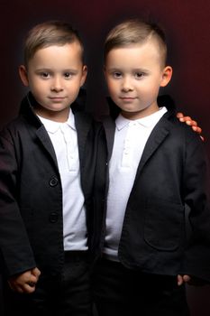 two little boys dressed in tuxedo. Isolated on white background