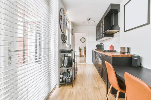 Pretty kitchen with black wood kitchen unit