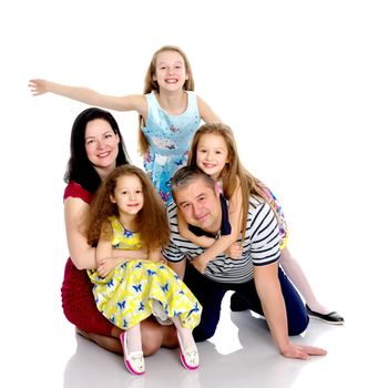 Happy family with young children. The concept of family happiness and development of children. Isolated on white background.