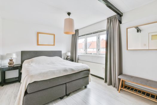 Interior of a lovely bedroom in light grey colors