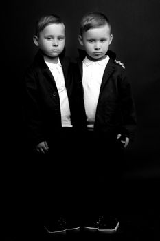 two little boys dressed in tuxedo. Isolated on white background