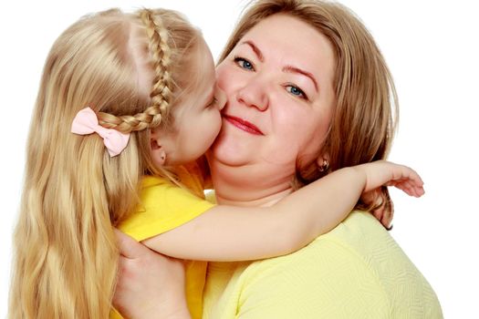 Mom and little daughter plus the size of the model, gently embrace. A woman and her daughter are smiling in a happy manner. Good for the concept of health, happiness, diet, obesity, weight loss.