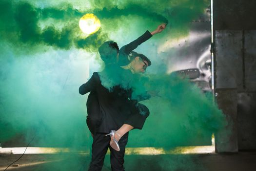 Pasadoble, latin solo dance and contemporary dance - Handsome man and woman dancing into smoke cloud