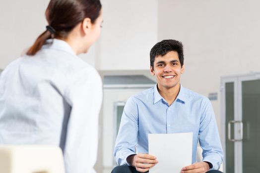 portrait of a young man at a business meeting. concept of team work