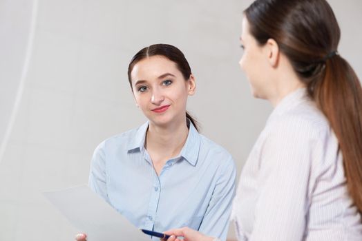 a young attractive woman talking to a colleague. Team concept