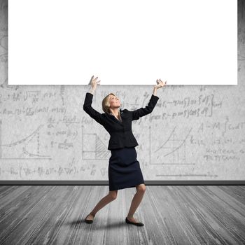 Beautiful woman in suit holding overhead big white banner. Blank whiteboard template with copy space for message. Businesswoman something presentation and promotion. Business advertising and marketing