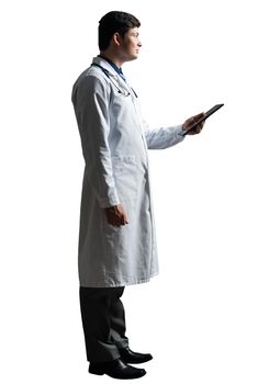 young doctor with a tablet computer, in a white medical coat and with a stethoscope