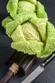 Fresh healthy savoy cabbage. Dark background. Top view.
