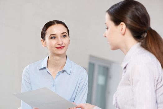 a young attractive woman talking to a colleague. Team concept