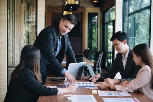 Business team working together and training to analyze technical price graph and indicator. Chart and stock trading computer screen