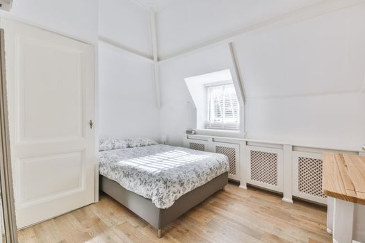 Attractive cozy bedroom with a big window