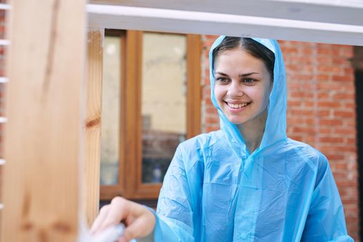 woman in protective suit painting wood renovation design. High quality photo
