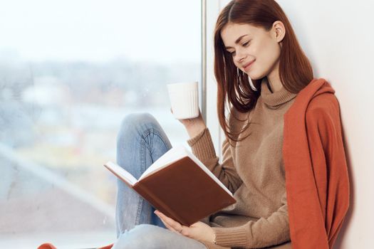 woman looking out the window on the windowsill Comfort weekend rest. High quality photo