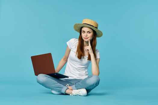 woman with laptop learning internet online education blue background. High quality photo