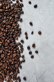 Roasted coffee beans on rustic table. White background. Top view. Copy space.