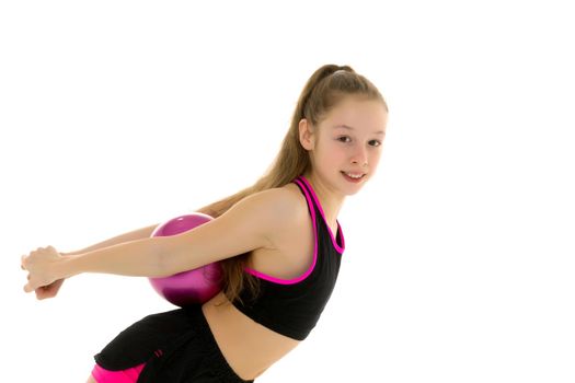 Beautiful little girl gymnast performs exercises with the ball. The concept of children's sports, fitness. Isolated on white background.