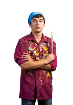 Young male painter artist holding paintbrush. Portrait of painter in dirty shirt and bandana standing on white background. Creative hobby and artistic occupation. Art school courses concept.