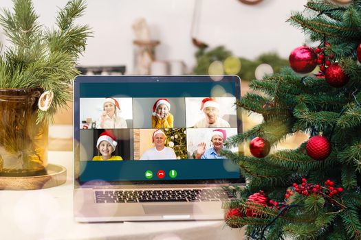 video call with happy diverse children on laptop computer in his workshop. Self-isolation and virtual online celebration at home concept. Christmas.