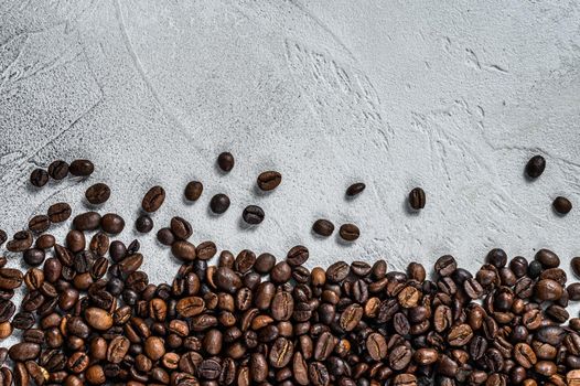 Roasted coffee beans on rustic table. White background. Top view. Copy space.