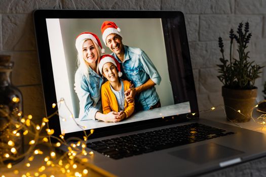 young family video call smiling and looking at webcam web, lovers greet friends merry christmas and happy new year.