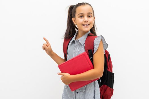 little schoolgirl shows on white background.