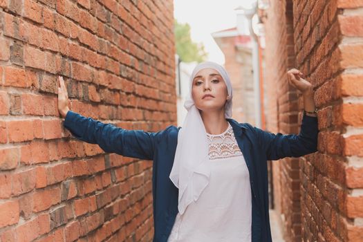 Portrait of a Muslim woman posing outdoors. Modern islamic female concept.