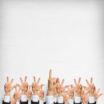 Group of hands of businesspeople showing gestures on wooden background