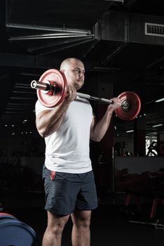 Man in the gym lifts the barbell. bodybuilding and healthy lifestyle