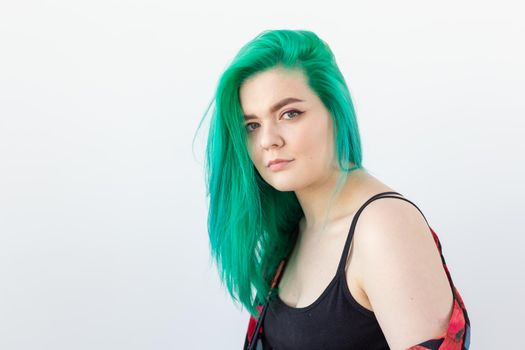 Hairstyle, youth, fashion and style concept - young beautiful woman with green hair over the white background with copy space.