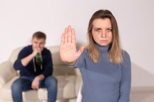 Alcoholism, abuse and problem concept - Sad woman shows stop sign, stop domestic violence.