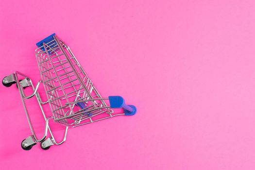 shopping cart isolated on pink background.