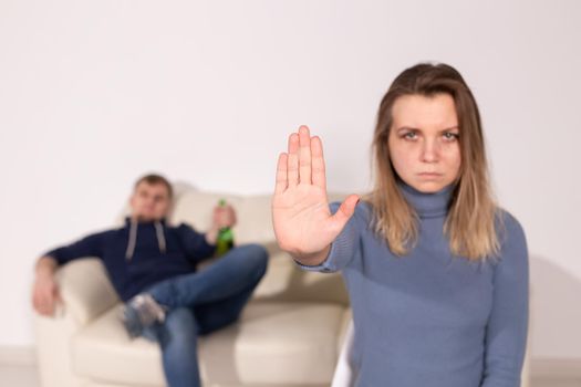 Alcoholism, abuse and problem concept - Sad woman shows stop sign, stop domestic violence.