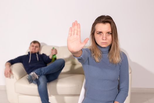 Alcoholism, abuse and problem concept - Sad woman shows stop sign, stop domestic violence.