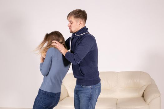 People, abuse and violence concept - aggressive man strangling his wife.