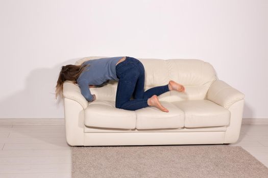 People, violence and abuse concept - Man drinking alcohol while wife is lying on sofa.