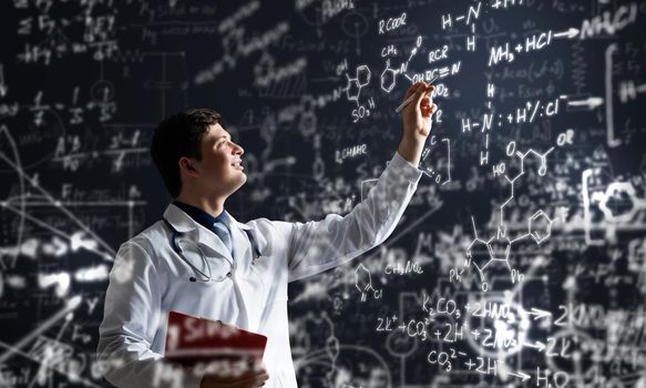 young scientist works with scientific formulas. mixed media