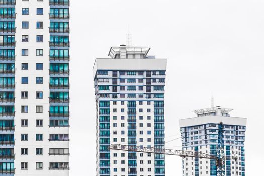 New modern high-rise apartment urban building exterior, facade of a residential city house.