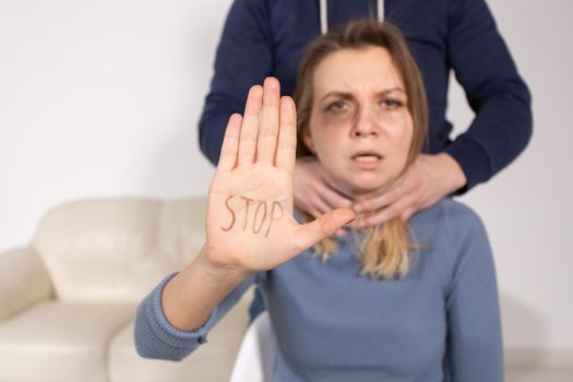 Alcoholism, abuse and problem concept - Sad woman shows stop sign, stop domestic violence.