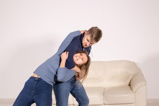 People, abuse and violence concept - aggressive man strangling his wife.