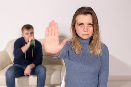 Alcoholism, abuse and problem concept - Sad woman shows stop sign, stop domestic violence.