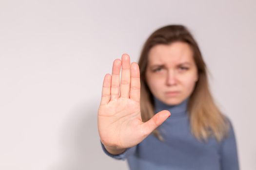 Abuse, domestic violence, protesting and people concept - Stop violence against women on grey background with copy space.