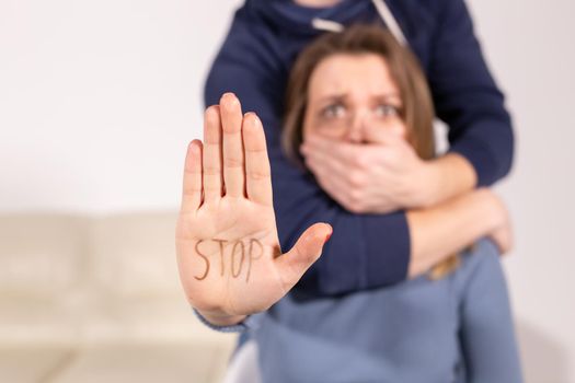 Alcoholism, abuse and problem concept - Sad woman shows stop sign, stop domestic violence.