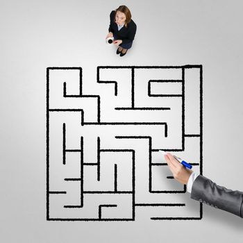 Top view of businesswoman with cup of coffee and drawn maze on floor